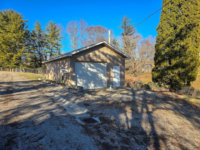 view of home's exterior featuring an outbuilding and a garage