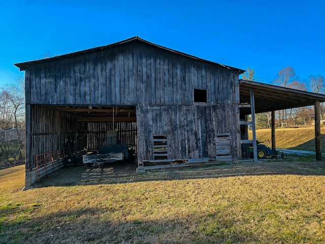 view of outbuilding with a yard