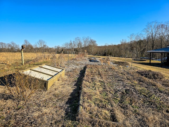 entry to storm shelter featuring a rural view