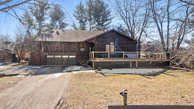 view of front of home featuring a garage and a deck