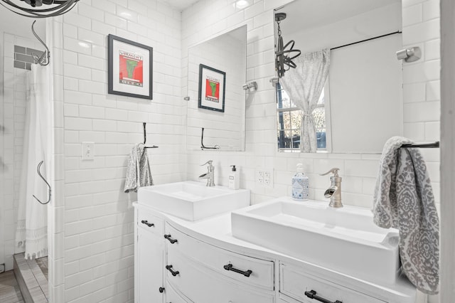 bathroom with tile walls, vanity, and tasteful backsplash