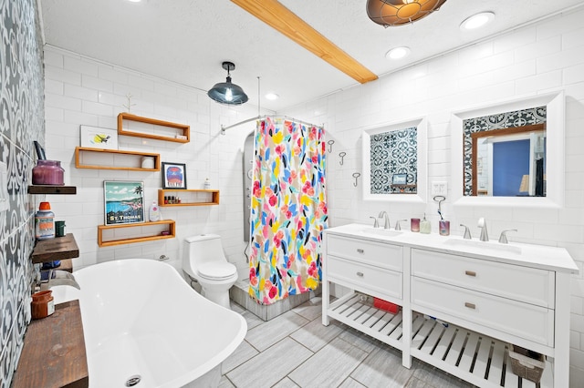 full bathroom featuring tile walls, separate shower and tub, vanity, a textured ceiling, and toilet