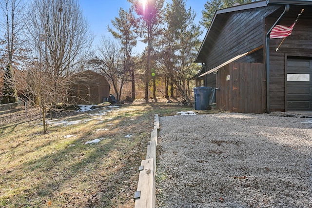 view of yard featuring a garage and an outdoor structure