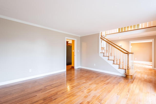 spare room with hardwood / wood-style flooring and ornamental molding