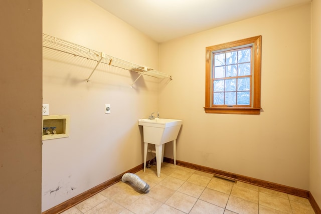 laundry room with electric dryer hookup, sink, hookup for a washing machine, and light tile patterned flooring