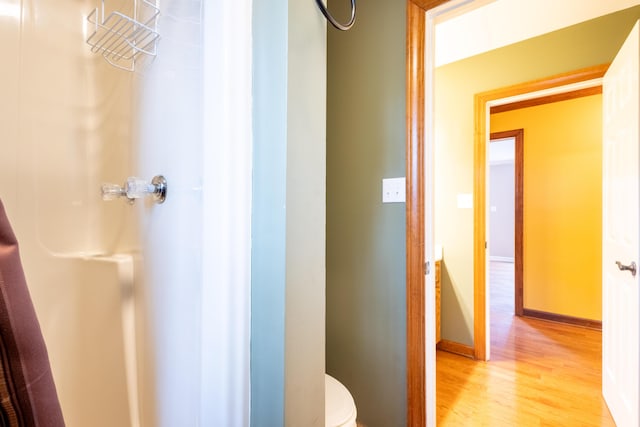 bathroom with wood-type flooring and toilet