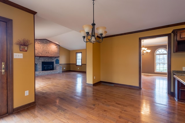 interior space with plenty of natural light, a fireplace, and a chandelier