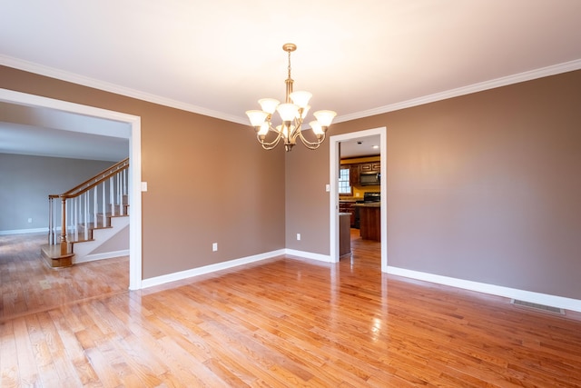 unfurnished room featuring wood-type flooring, ornamental molding, and a chandelier