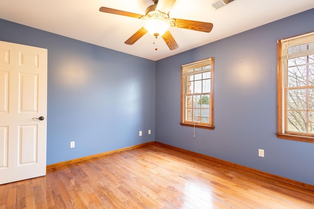 empty room featuring light hardwood / wood-style flooring and ceiling fan