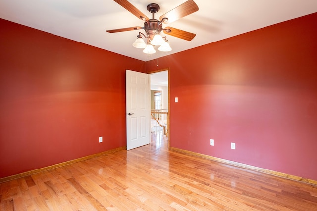 empty room with ceiling fan and light hardwood / wood-style flooring