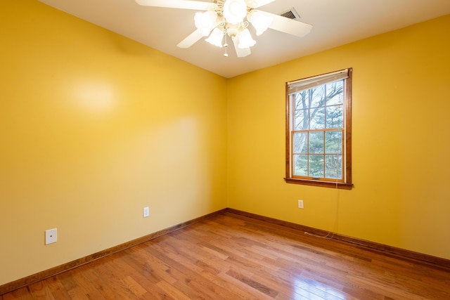 unfurnished room with hardwood / wood-style floors and ceiling fan