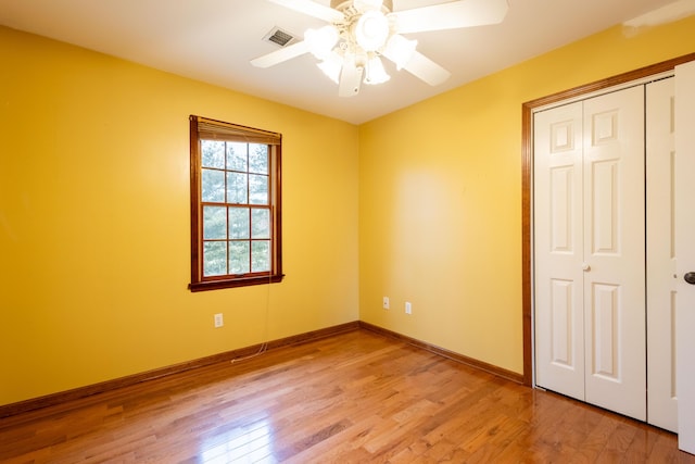 unfurnished bedroom with a closet, ceiling fan, and light hardwood / wood-style flooring