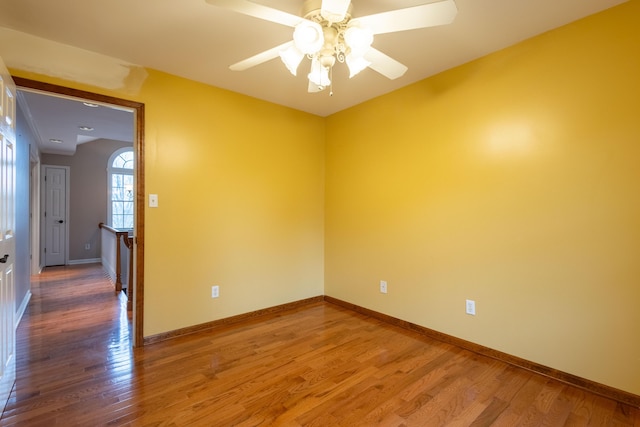 spare room featuring hardwood / wood-style floors and ceiling fan