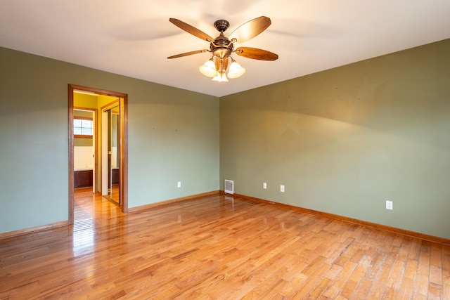 empty room with light hardwood / wood-style floors and ceiling fan