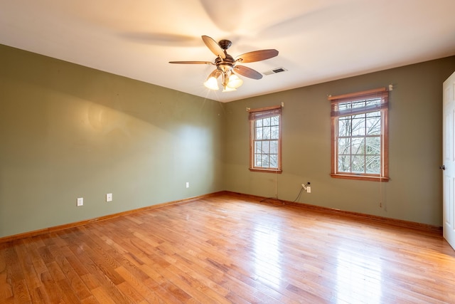 empty room featuring ceiling fan and light hardwood / wood-style flooring