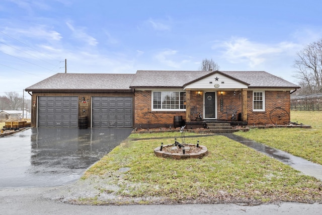 ranch-style house featuring a garage and a front lawn