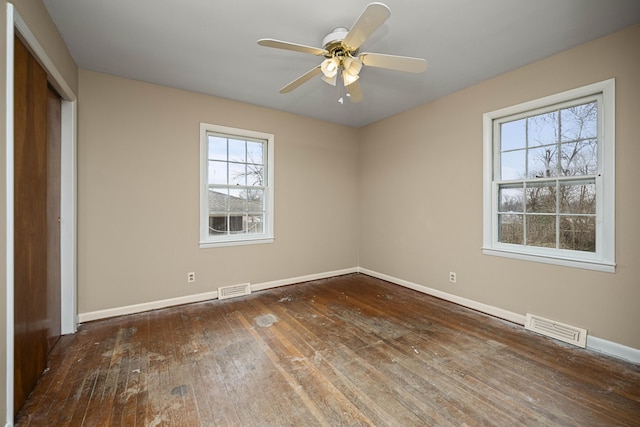 unfurnished bedroom featuring dark wood-type flooring, ceiling fan, and a closet