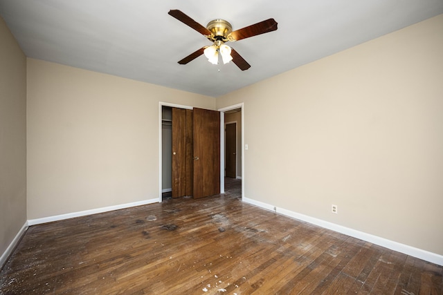 unfurnished bedroom with ceiling fan, dark hardwood / wood-style flooring, and a closet