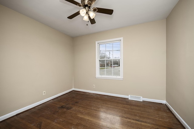 spare room with dark hardwood / wood-style floors and ceiling fan