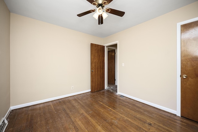 spare room featuring ceiling fan and dark hardwood / wood-style flooring