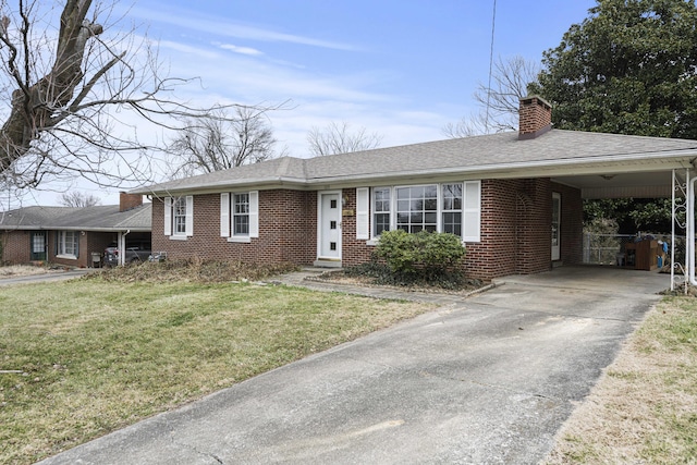 view of front of house with a front yard and a carport