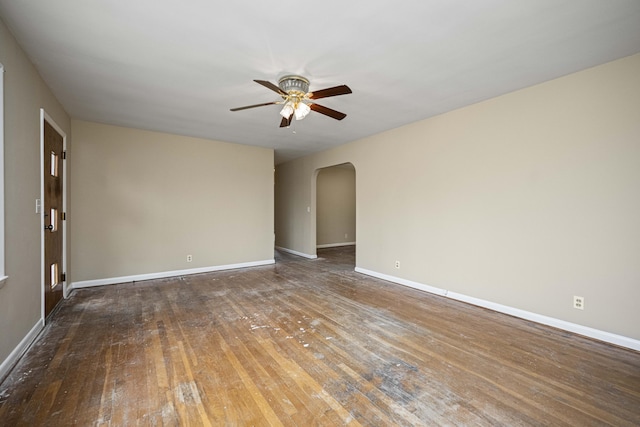 spare room with dark hardwood / wood-style floors and ceiling fan