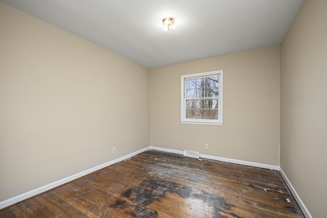 spare room with dark hardwood / wood-style flooring