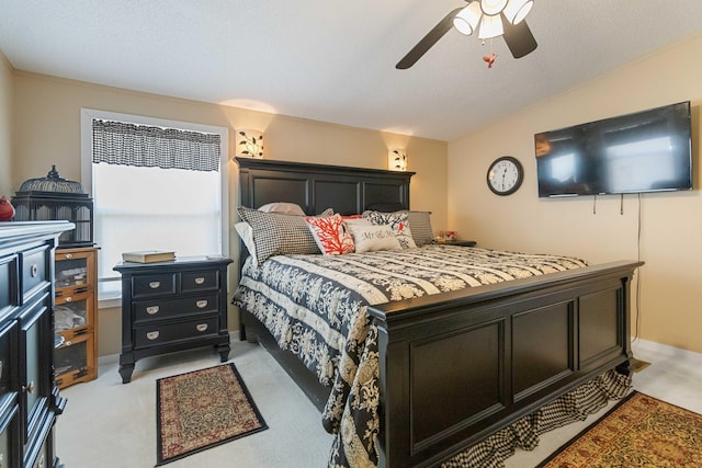 bedroom with light colored carpet, ceiling fan, and vaulted ceiling