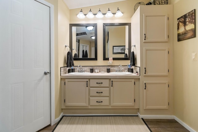 bathroom featuring tasteful backsplash and vanity