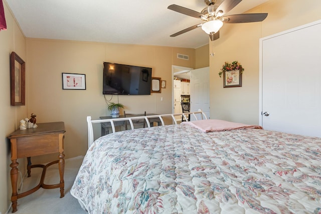 bedroom with lofted ceiling, ceiling fan, and carpet