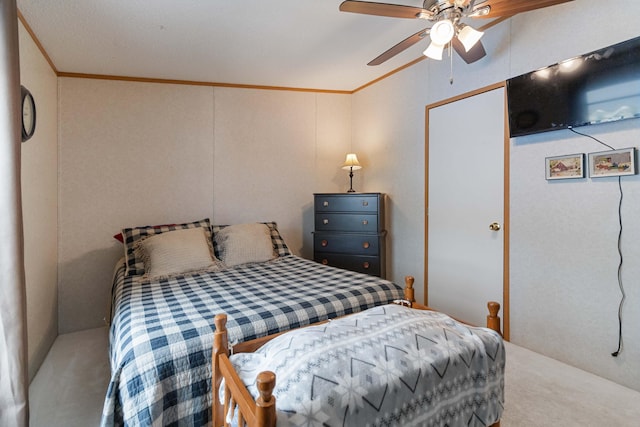 bedroom featuring ornamental molding, carpet flooring, and ceiling fan