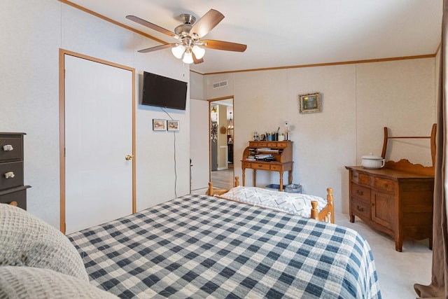 carpeted bedroom featuring crown molding and ceiling fan