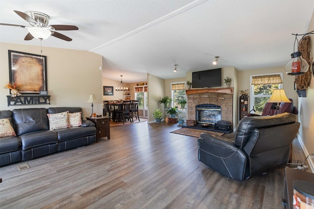 living room featuring a wealth of natural light, lofted ceiling, hardwood / wood-style floors, and ceiling fan