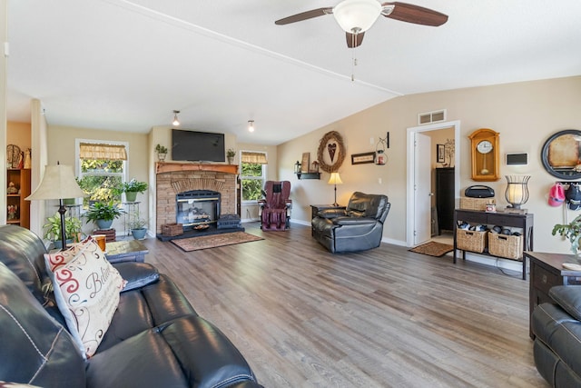 living room featuring wood-type flooring, lofted ceiling, and ceiling fan