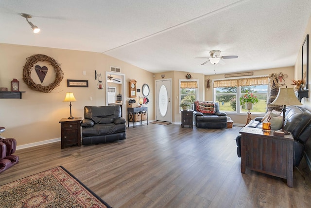 living room with lofted ceiling, dark hardwood / wood-style floors, and ceiling fan