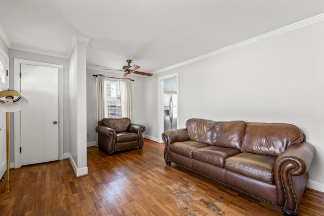 living room with crown molding, ceiling fan, and dark hardwood / wood-style floors