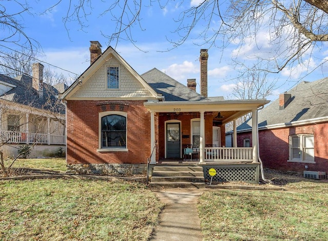 view of front of property featuring central AC, a porch, and a front lawn