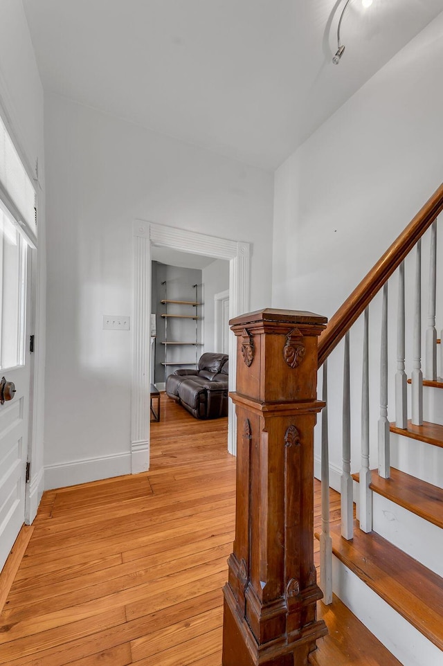 staircase with hardwood / wood-style floors