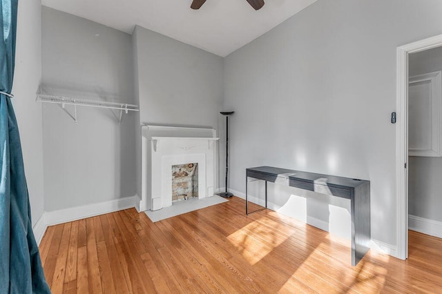 unfurnished living room with wood-type flooring and ceiling fan