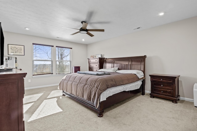 bedroom with ceiling fan and light carpet