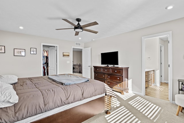 carpeted bedroom featuring a spacious closet, ceiling fan, and a closet