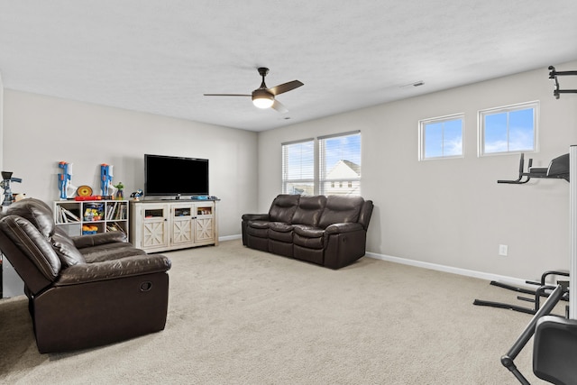 living room featuring ceiling fan, carpet, and a textured ceiling