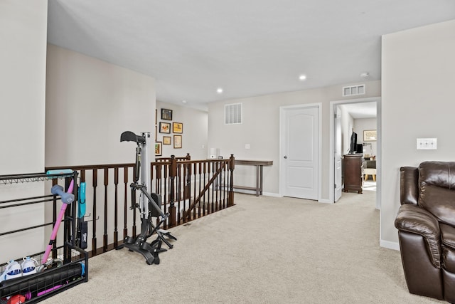 exercise room with light colored carpet