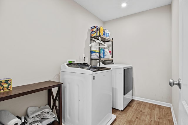 washroom with light hardwood / wood-style flooring and independent washer and dryer