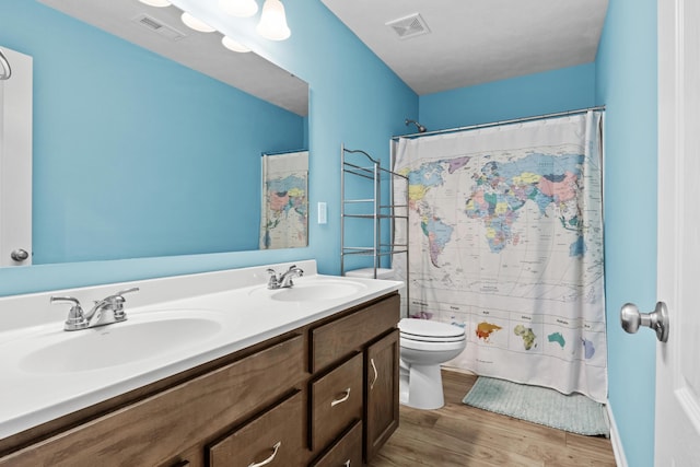 bathroom with hardwood / wood-style flooring, vanity, toilet, and a shower with curtain