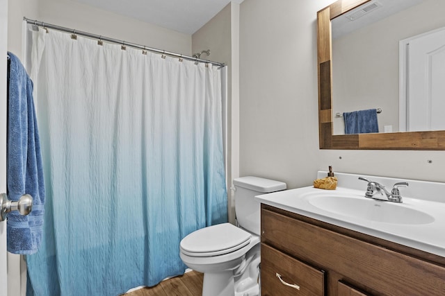 full bathroom with hardwood / wood-style flooring, shower / bathtub combination with curtain, vanity, and toilet