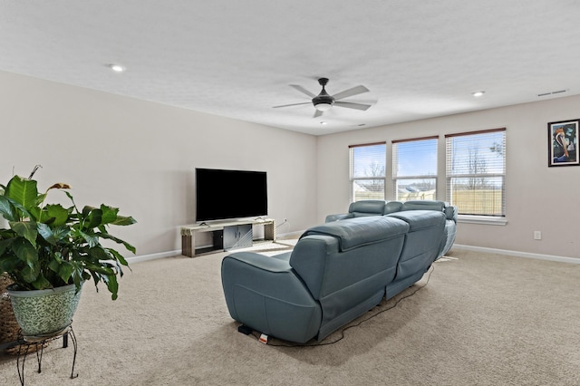 carpeted living room with ceiling fan