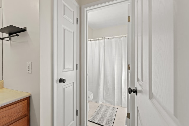 bathroom featuring vanity, a shower with curtain, and toilet