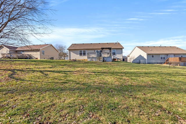 rear view of house featuring a lawn