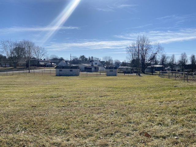 view of yard with a shed and a rural view